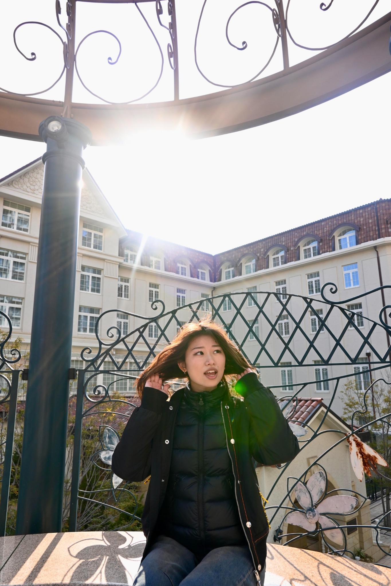 Instructor sitting outdoors with sun flares